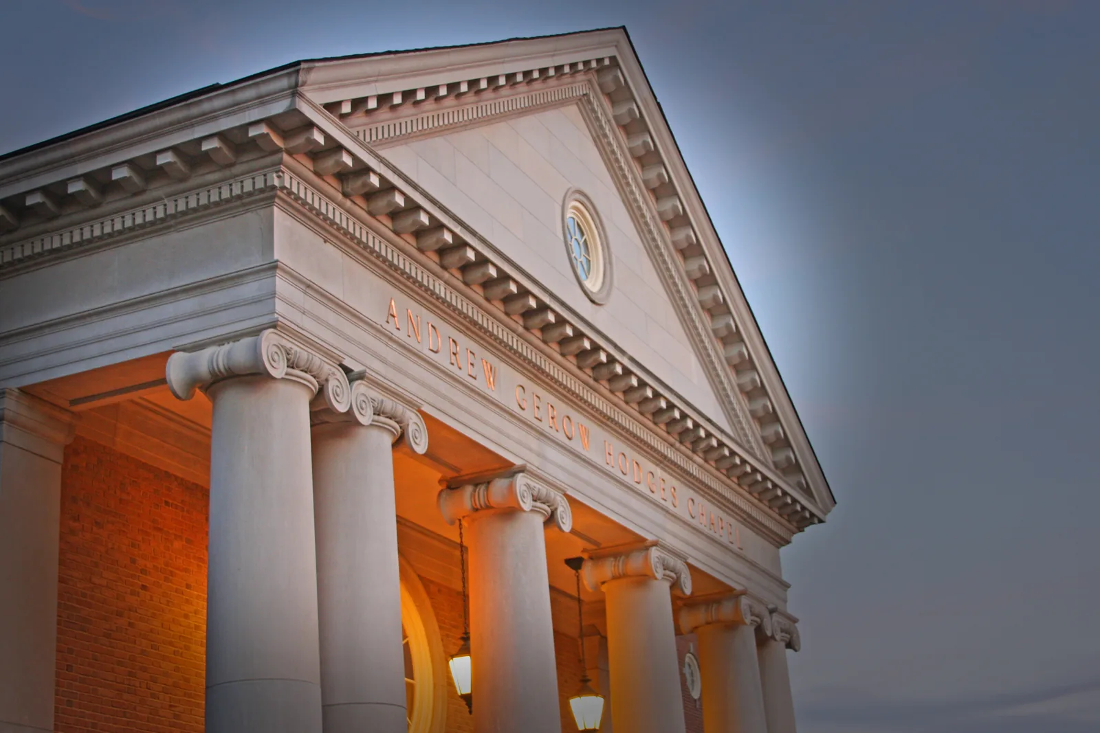 The columned portico of Andrew Gerow Hodges Chapel at Samford University in Homewood, lit at night.