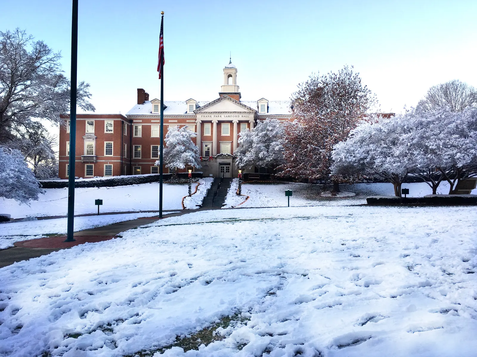 Snow on the lawns and trees in front of a Samford University building in Homewood.