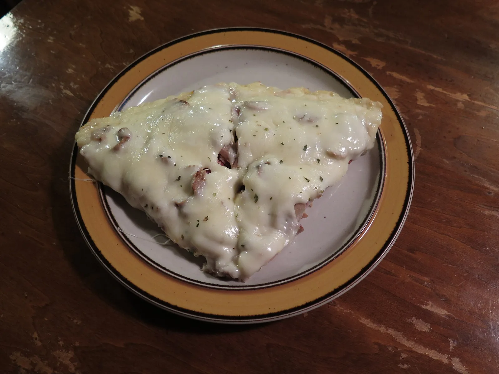 Two slices of supreme pizza on a plate.
